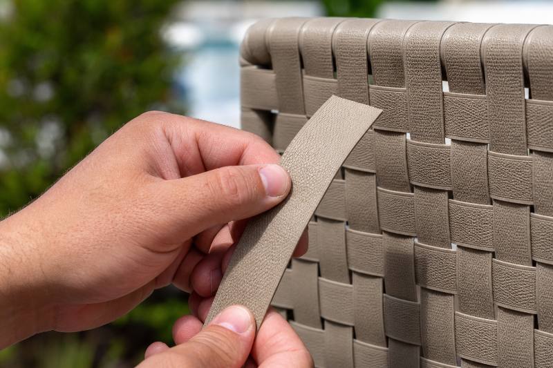 Strap Sample Ordering: 5 Proven Benefits for a Perfect... 4 A person carefully examining a patio furniture strap sample, comparing its color and texture against an existing piece of furniture, highlighting the precision of Strap Sample Ordering.